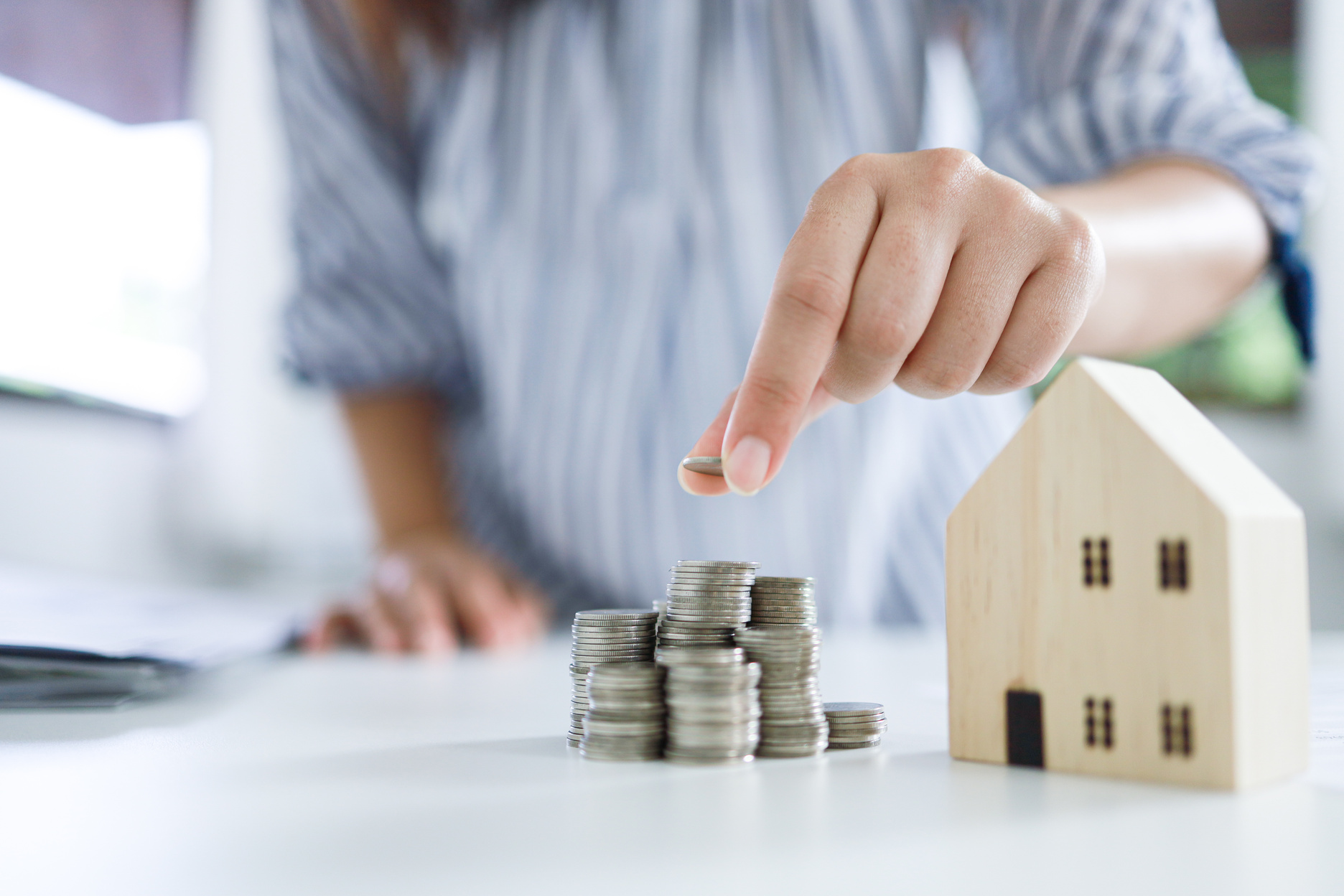 Saving money for Real estate investment with with stack of money